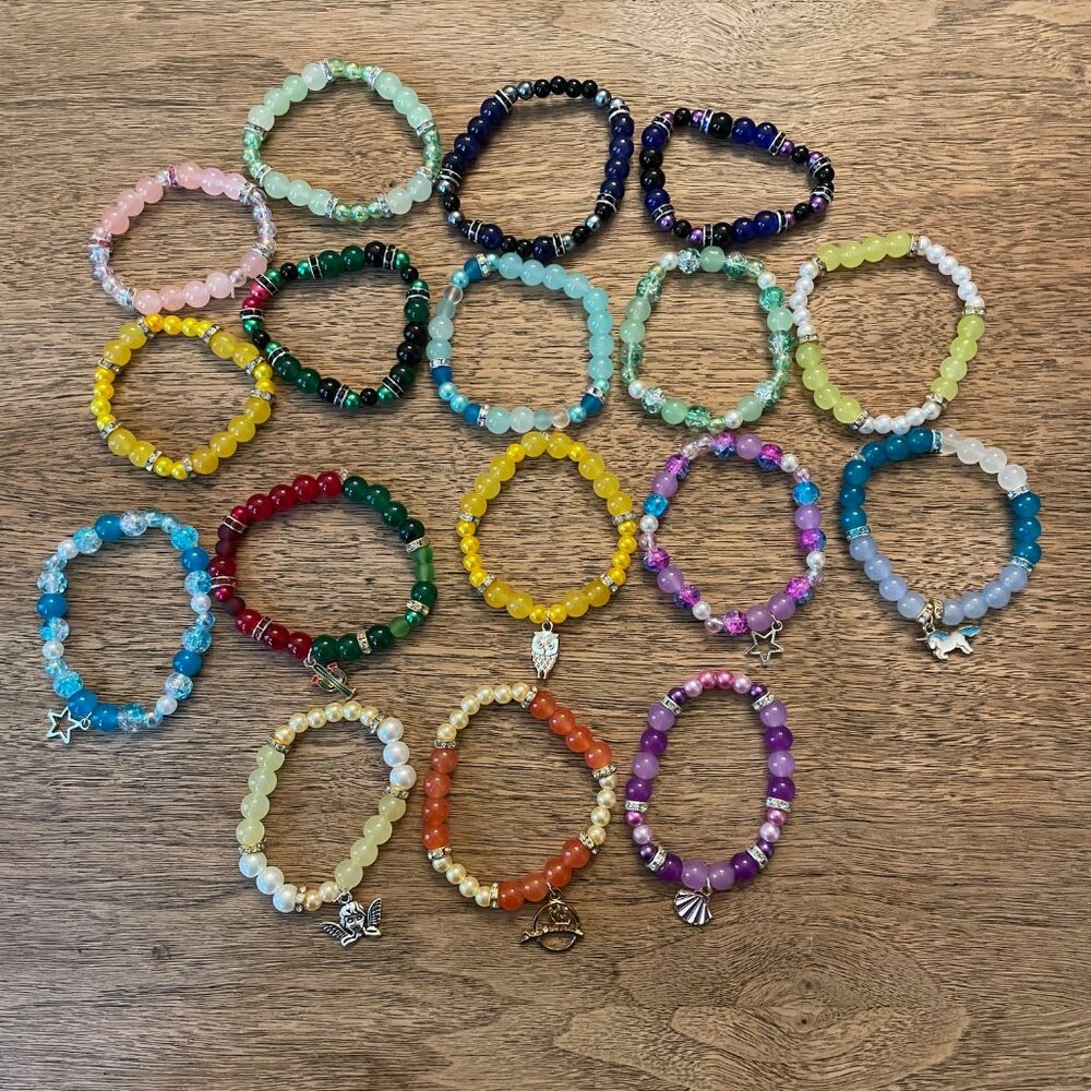 Lot of 17 colorful stretchy beaded bracelets with charms! Cool Halloween gift!